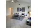 Living room with comfortable seating area and decoratively painted accent wall and tile floors at 824 Greenbelt Cir, Brandon, FL 33510