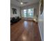 Bright living room featuring hardwood floors, bright windows with shutters, and modern decor at 824 Greenbelt Cir, Brandon, FL 33510