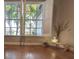 Bright living room featuring hardwood floors, bright windows with shutters, and minimal decor at 824 Greenbelt Cir, Brandon, FL 33510