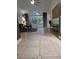 Open-concept living room featuring tile flooring, high ceilings, and views to backyard at 824 Greenbelt Cir, Brandon, FL 33510