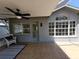 Covered patio featuring a ceiling fan and a comfortable wicker chair at 824 Greenbelt Cir, Brandon, FL 33510