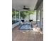 Cozy screened patio with ceiling fan and stylish outdoor seating, perfect for relaxation at 824 Greenbelt Cir, Brandon, FL 33510