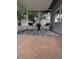 Enclosed patio featuring tile flooring, two wicker chairs, and bright, natural light at 824 Greenbelt Cir, Brandon, FL 33510