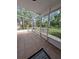 Spacious screened porch with tile flooring, offering views of the private, landscaped backyard at 824 Greenbelt Cir, Brandon, FL 33510