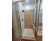 Walk-in shower with tiled walls, decorative glass door, and updated fixtures at 824 Greenbelt Cir, Brandon, FL 33510