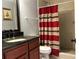 Bathroom featuring granite counters, a shower with a striped curtain, and neutral tile at 8516 N Dixon Ave, Tampa, FL 33604