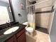 Modern bathroom features a walk-in shower with black accents and a dark wood vanity at 8516 N Dixon Ave, Tampa, FL 33604