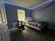 Serene bedroom featuring soft lighting, a dedicated desk space, and wood floors at 8516 N Dixon Ave, Tampa, FL 33604