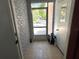 Entryway featuring tile floors, a storm door, and access to other parts of the home at 8516 N Dixon Ave, Tampa, FL 33604