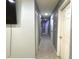 Neutral-toned hallway featuring multiple doorways and recessed lighting, offering a glimpse into various areas of the home at 8516 N Dixon Ave, Tampa, FL 33604