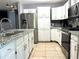 Modern kitchen featuring granite countertops, white cabinetry, and stainless steel appliances for the discerning chef at 8516 N Dixon Ave, Tampa, FL 33604