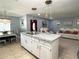 Open-concept kitchen featuring granite countertops, a large island, and seamless flow into the dining and living areas at 8516 N Dixon Ave, Tampa, FL 33604