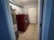 Functional laundry room features modern washer and dryer, water heater, and ample storage space at 8516 N Dixon Ave, Tampa, FL 33604