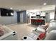 Spacious open-concept living area with a view of the modern kitchen, comfortable seating, and ample space for relaxation at 8516 N Dixon Ave, Tampa, FL 33604