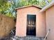 Exterior view of shed with a dark door and peach colored walls at 8516 N Dixon Ave, Tampa, FL 33604