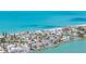 An aerial view showcases waterfront community with colorful homes and boat docks at 8801 Gulf Blvd, St Petersburg, FL 33706