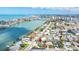 Aerial view featuring a waterfront community, beach, intercoastal waterway, and beautiful houses at 8801 Gulf Blvd, St Petersburg, FL 33706