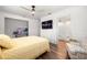 Bedroom with wood floors, ceiling fan, and view into the bathroom at 8801 Gulf Blvd, St Petersburg, FL 33706