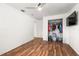 Bright bedroom featuring wood floors, closet, ceiling fan, and a TV at 8801 Gulf Blvd, St Petersburg, FL 33706