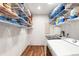 Well-organized laundry room with washer, dryer, and ample storage on wire shelving at 8801 Gulf Blvd, St Petersburg, FL 33706