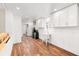 Efficient laundry area with white cabinets, stainless steel mini-fridge, wood-look flooring, and access to the outside at 8801 Gulf Blvd, St Petersburg, FL 33706