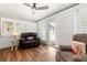Bright living room with wood floors, plantation shutters, and access to the patio at 8801 Gulf Blvd, St Petersburg, FL 33706