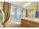Bathroom featuring a shower-tub combination, vanity with sink, and tiled walls at 965 Westwinds Blvd, Tarpon Springs, FL 34689