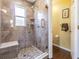 Beautiful bathroom with tiled shower, seating, and frameless glass doors at 965 Westwinds Blvd, Tarpon Springs, FL 34689