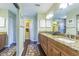 Bathroom with double vanity featuring granite countertops, framed mirror and a walk-in shower at 965 Westwinds Blvd, Tarpon Springs, FL 34689