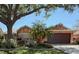 Charming single-story home with mature trees, manicured landscaping, and a spacious two-car garage at 965 Westwinds Blvd, Tarpon Springs, FL 34689