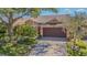 Inviting single-Gathering home featuring manicured landscaping and an attached two-car garage at 965 Westwinds Blvd, Tarpon Springs, FL 34689