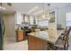 Bright kitchen featuring an island, granite countertops, stainless appliances, and modern cabinetry at 965 Westwinds Blvd, Tarpon Springs, FL 34689