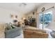 Cozy living room with vaulted ceilings and sliding doors to the screened lanai at 965 Westwinds Blvd, Tarpon Springs, FL 34689