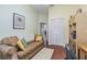 Cozy living room features a comfortable couch, hardwood floors and decorative wall art at 965 Westwinds Blvd, Tarpon Springs, FL 34689