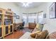 Bright office space with hardwood floors, a comfortable couch, and ample storage and natural light at 965 Westwinds Blvd, Tarpon Springs, FL 34689