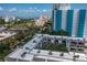 Beautiful aerial view of condo community with rooftop details near water, cityscape and lush greenery under blue sky at 105 4Th Ne Ave # 219, St Petersburg, FL 33701