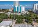 Aerial view of the property with tall buildings in the background and mature trees at 105 4Th Ne Ave # 219, St Petersburg, FL 33701