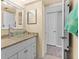 Bathroom with modern fixtures including a glass bowl sink, granite counter and framed mirror at 105 4Th Ne Ave # 219, St Petersburg, FL 33701