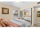 Well-lit bedroom with mirrored closet doors, large windows and a comfortable bed and chair at 105 4Th Ne Ave # 219, St Petersburg, FL 33701