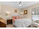 Cozy bedroom with a ceiling fan, neutral walls, and a comfortable bed with decorative pillows at 105 4Th Ne Ave # 219, St Petersburg, FL 33701