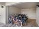 Enclosed storage area for residents to store bikes on tile flooring with dual lights at 105 4Th Ne Ave # 219, St Petersburg, FL 33701