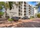 Condo building featuring a covered parking area, well maintained landscaping, and multiple balconies at 105 4Th Ne Ave # 219, St Petersburg, FL 33701