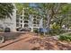 Exterior of Townview Condominiums with mature landscaping and a parking area in front at 105 4Th Ne Ave # 219, St Petersburg, FL 33701