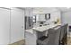 Modern kitchen with white cabinets, stainless steel appliances, and a breakfast bar with seating at 105 4Th Ne Ave # 219, St Petersburg, FL 33701
