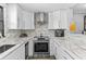 Bright kitchen featuring stainless steel appliances, white cabinets, and tile backsplash at 105 4Th Ne Ave # 219, St Petersburg, FL 33701