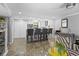 Open-concept living area boasts modern kitchen bar, stylish seating, and sleek tiled flooring at 105 4Th Ne Ave # 219, St Petersburg, FL 33701