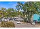 Property view of a well-maintained parking lot surrounded by mature trees and landscaping at 105 4Th Ne Ave # 219, St Petersburg, FL 33701