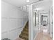 Staircase with tiled steps and white walls adjacent to the main living area with tiled floors at 105 4Th Ne Ave # 219, St Petersburg, FL 33701