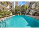 Community swimming pool surrounded by lounge chairs and tropical landscaping at 105 4Th Ne Ave # 219, St Petersburg, FL 33701