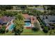 Stunning aerial view of home, pool, and golf course in a lush, established neighborhood at 10600 Indian Hills Ct, Seminole, FL 33777